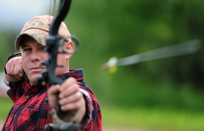 A man firing an arrow from a bow