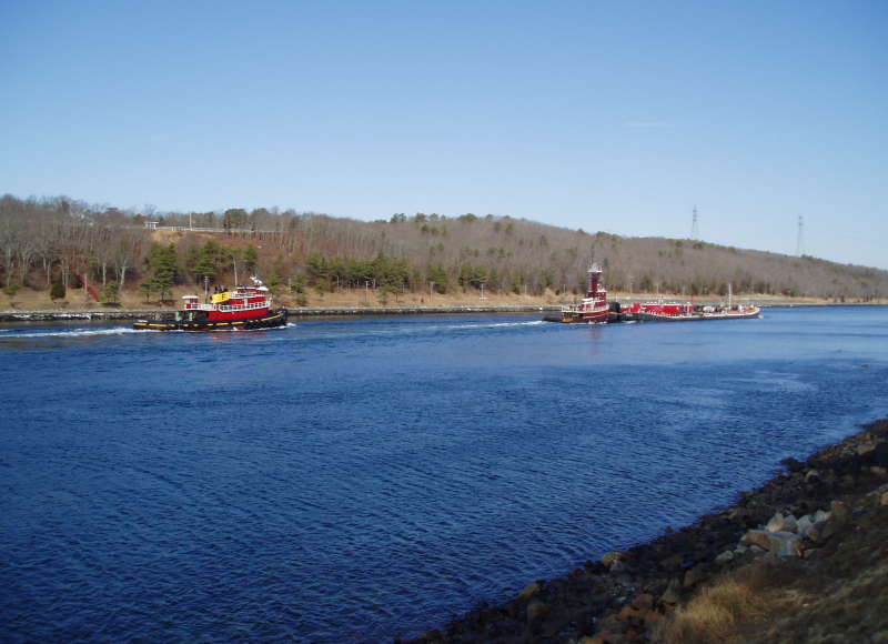 tug escorting an oil barge through Cape Cod Canal