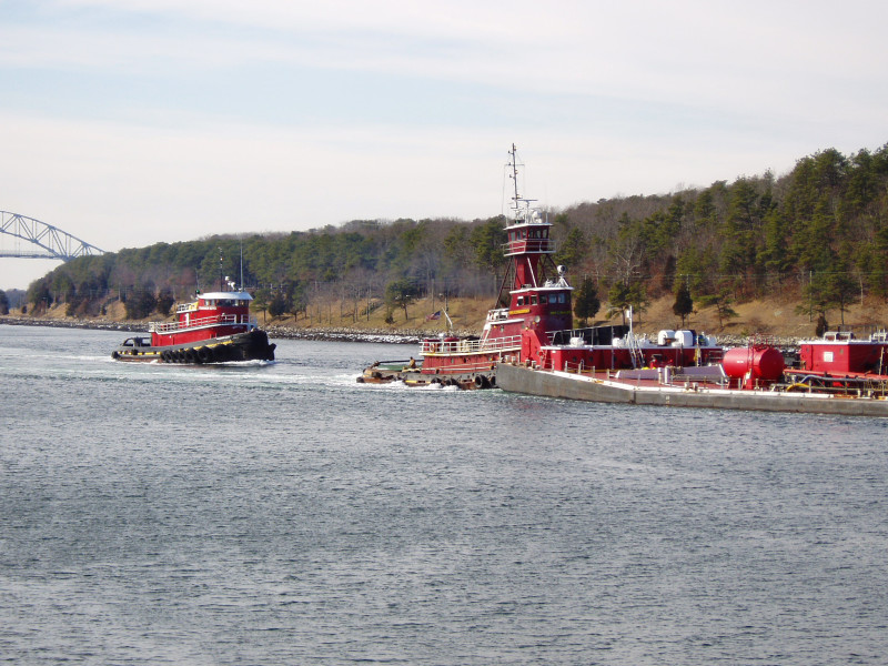 A tug escorts an oil barge through Cape Cod Canal