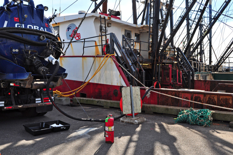 Bilge pumpout truck next to a commercial fishing vessel on New Bedford Harbor