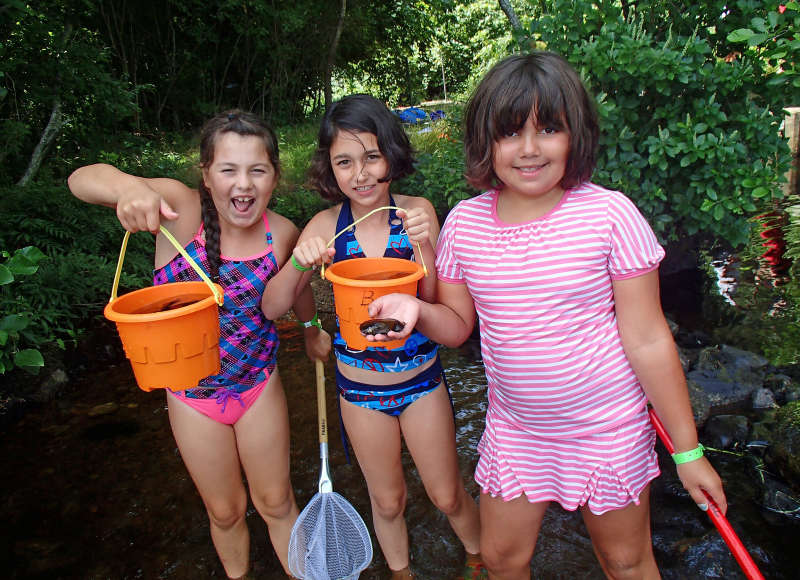 three girls with beach pails