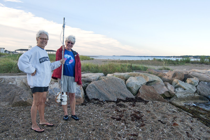 two women holding water testing sampling pole in New Bedford