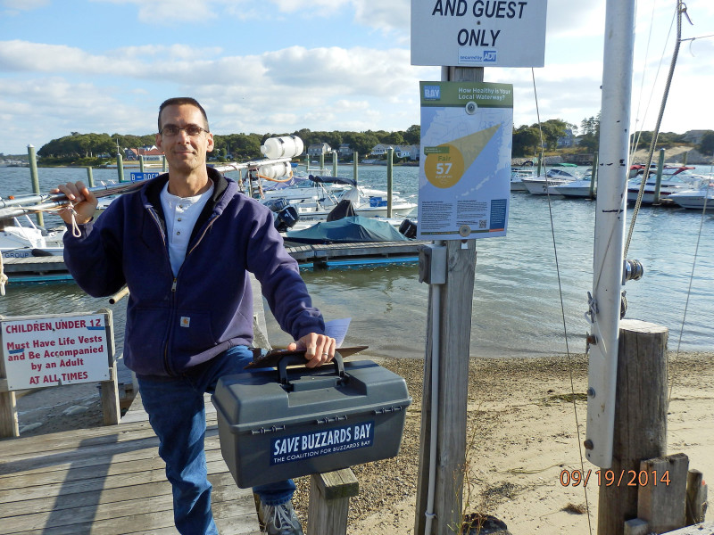 a man holding his water testing sampling pole and kit on Buttermilk Bay