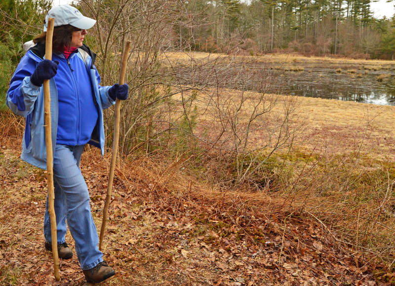 a woman walking on a trail in Wareham