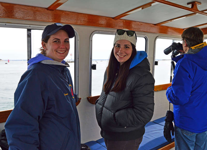 two women inside a boat on a seal watch in Woods Hole