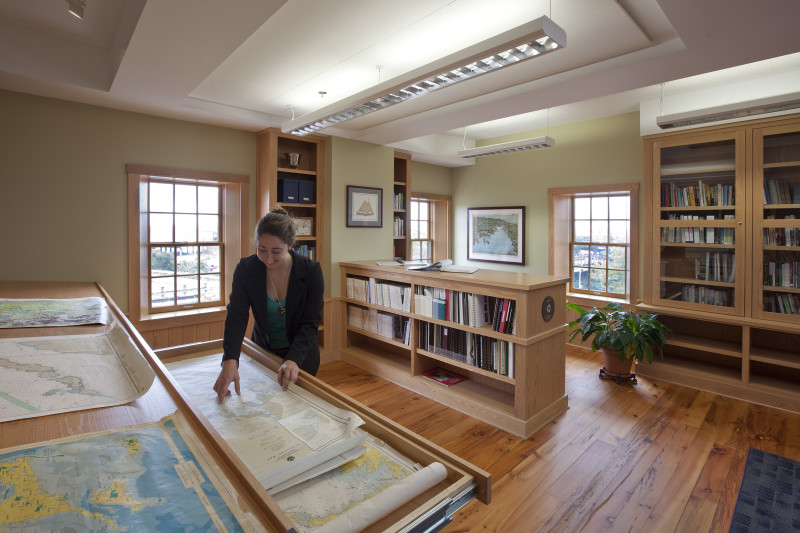 woman looking at maps in the Buzzards Bay Center library