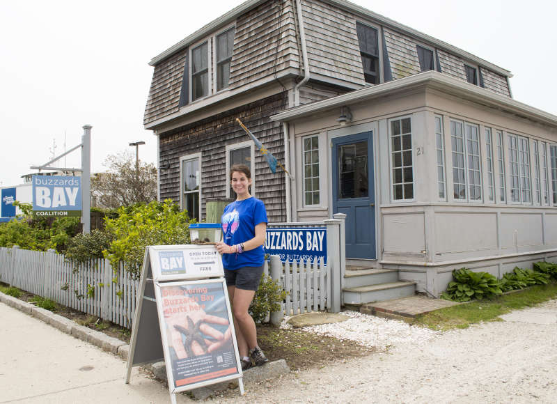 Buzzards Bay Discovery Center staff member standing outside the center in Woods Hole