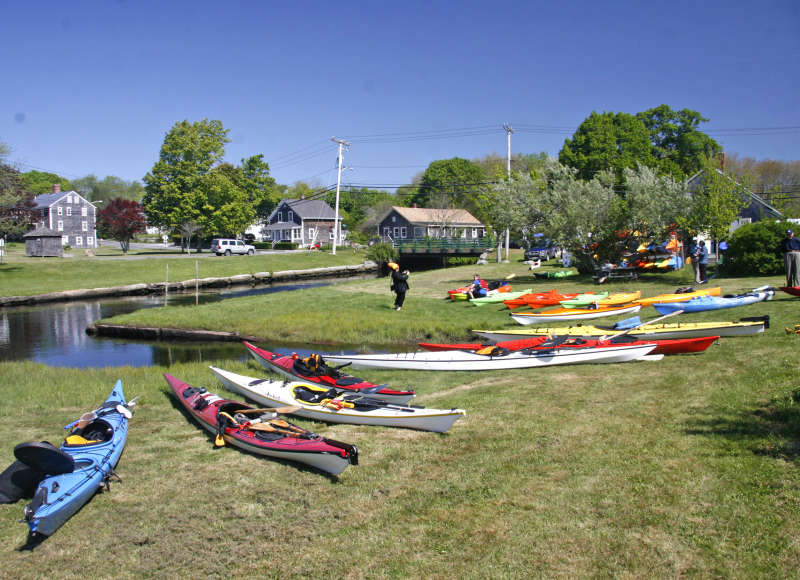 a group of kayaks sit by the launch at the Head of Westport Town Landing