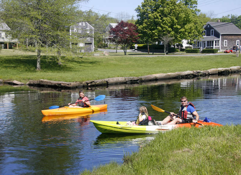 three people in kayaks on the East Branch of the Westport River at the Head of Westport Town Landing