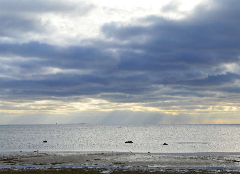 clouds and sun rays over Buzzards Bay from Little Harbor Beach