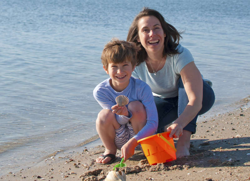 a mother and son collect shells on Silvershell Beach in Marion