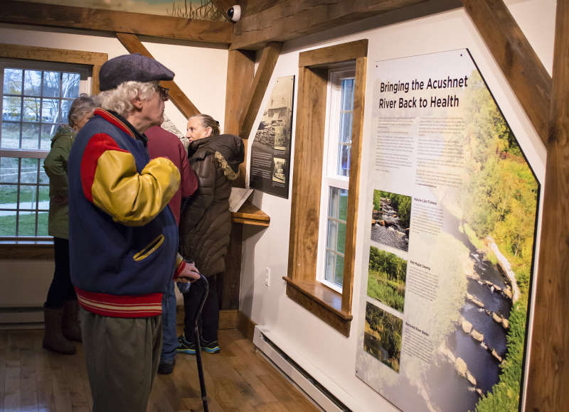 a man reads an informational panel at The Sawmill