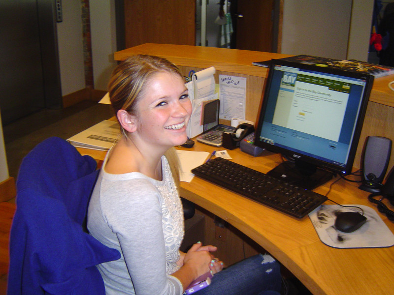 a female volunteer at a computer at the Buzzards Bay Center in New Bedford