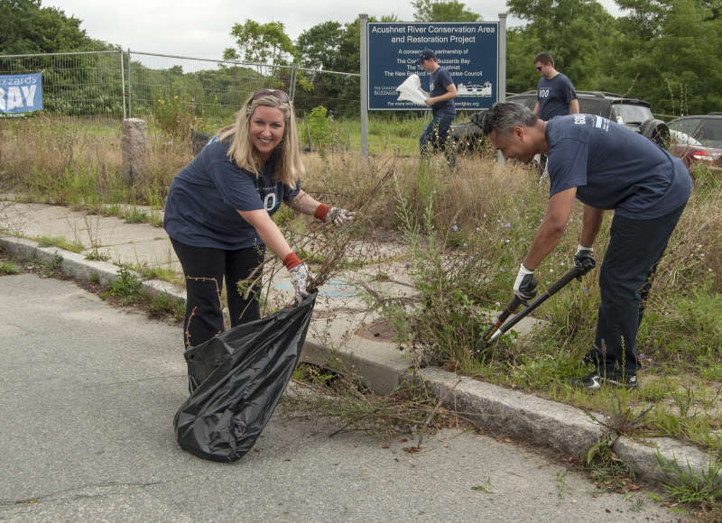 two volunteers pulling weeds at The Sawmill in Acushnet