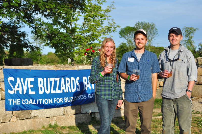 three people drinking Sow & Pigs Ale at Buzzards Bay Brewing in Westport