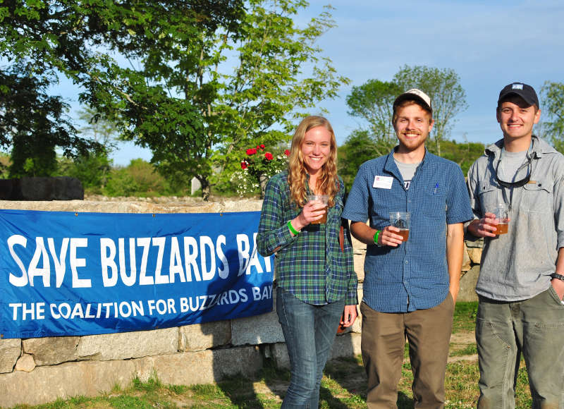 three people drinking Sow & Pigs Ale at Buzzards Bay Brewing in Westport