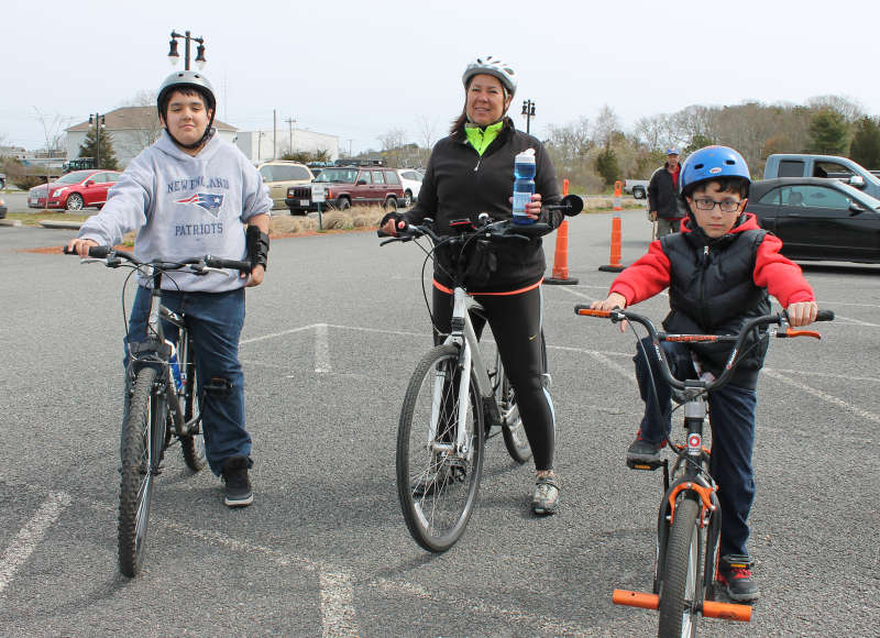 a grandmother and two boys on bikes at Buzzards Bay Recreation Area in Bourne