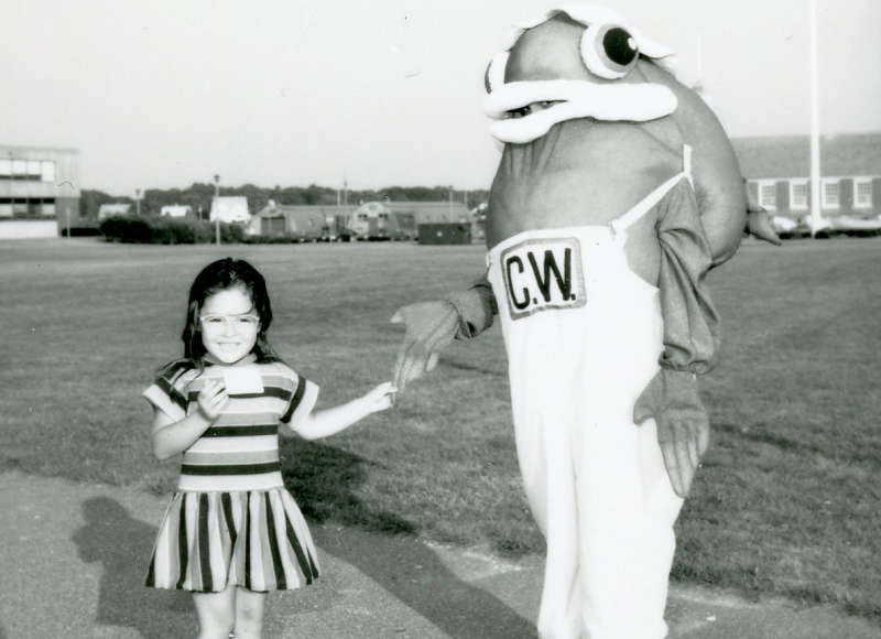 a little girl and Buzzards Bay Coalition fish mascot at an event in the 1980s