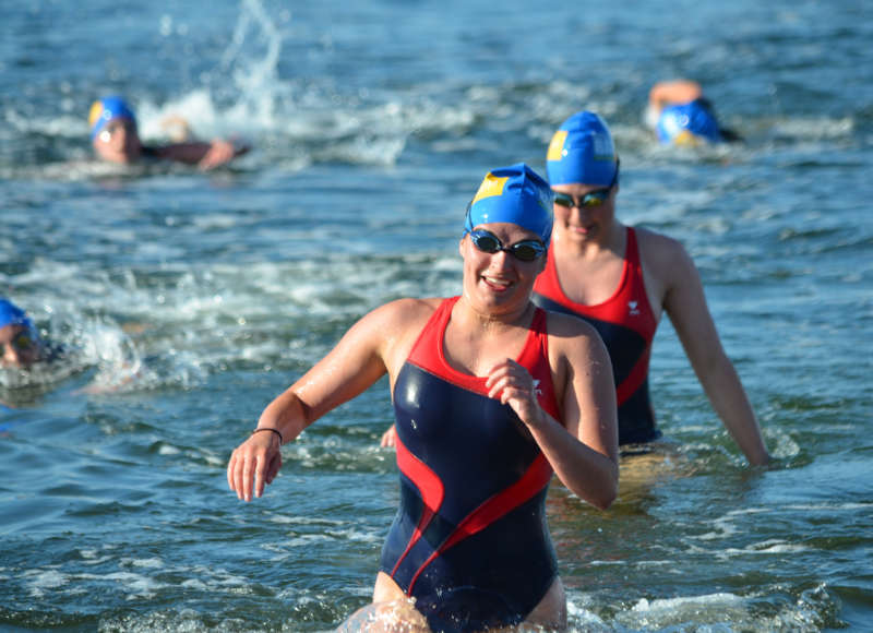 female swimmers coming out of the water at the Buzzards Bay Swim