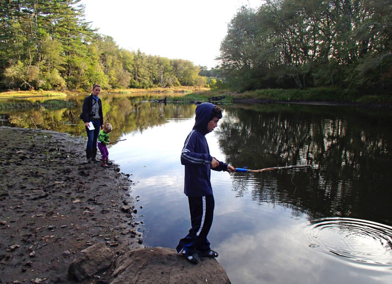 a family fishing in the Weweantic River at Horseshoe Mill