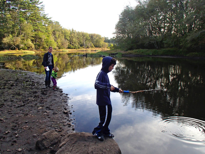 a family fishing in the Weweantic River at Horseshoe Mill