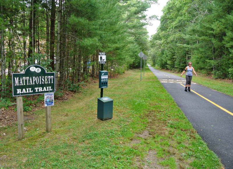 a woman rollerblading on the Mattapoisett Rail Trail