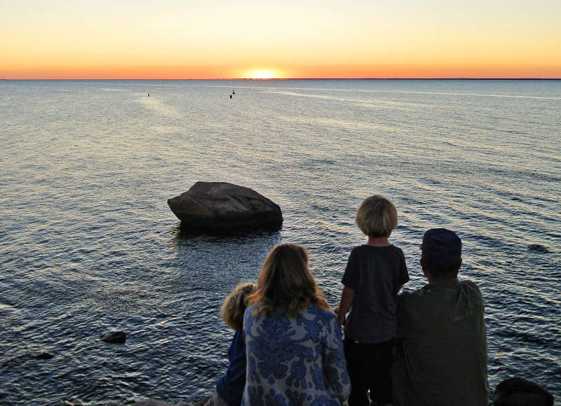 a family watching the sunset over Buzzards Bay at The Knob in Falmouth