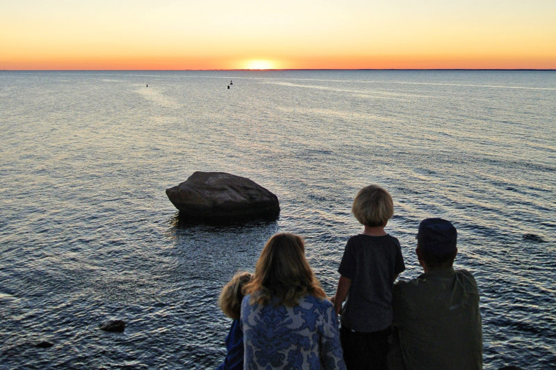 a family watching the sunset over Buzzards Bay at The Knob in Falmouth