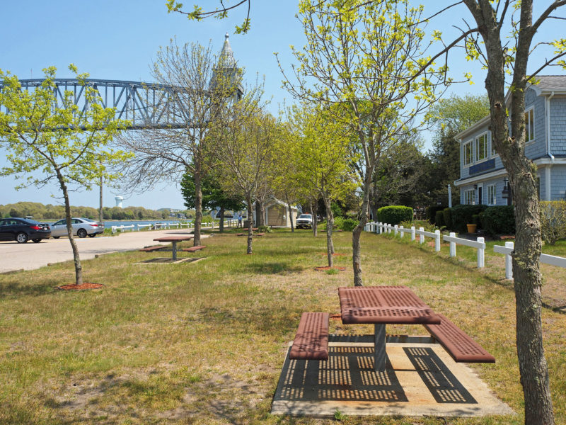 Picnic tables with the railroad bridge in the background at Tidal Flats Recreation Area