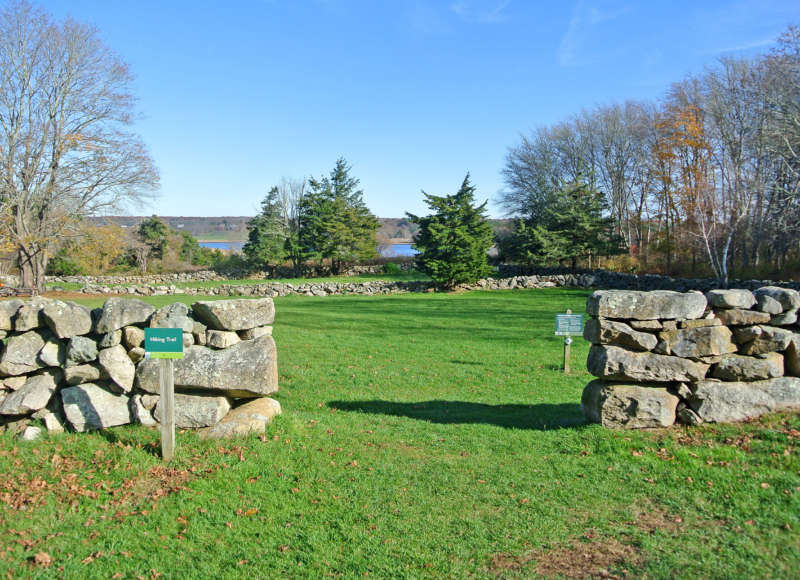 trail through a stone wall at Westport Town Farm