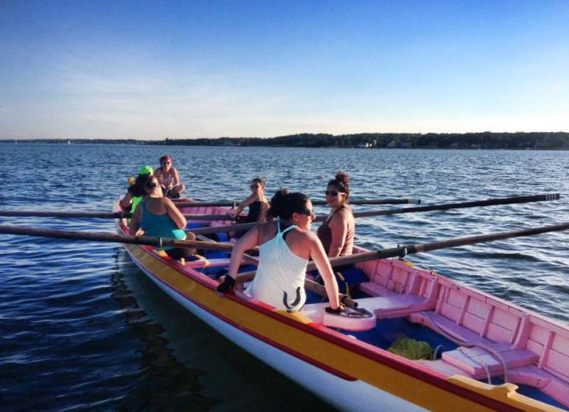 women sitting on an Azorean whaleboat in Clarks Cove in New Bedford