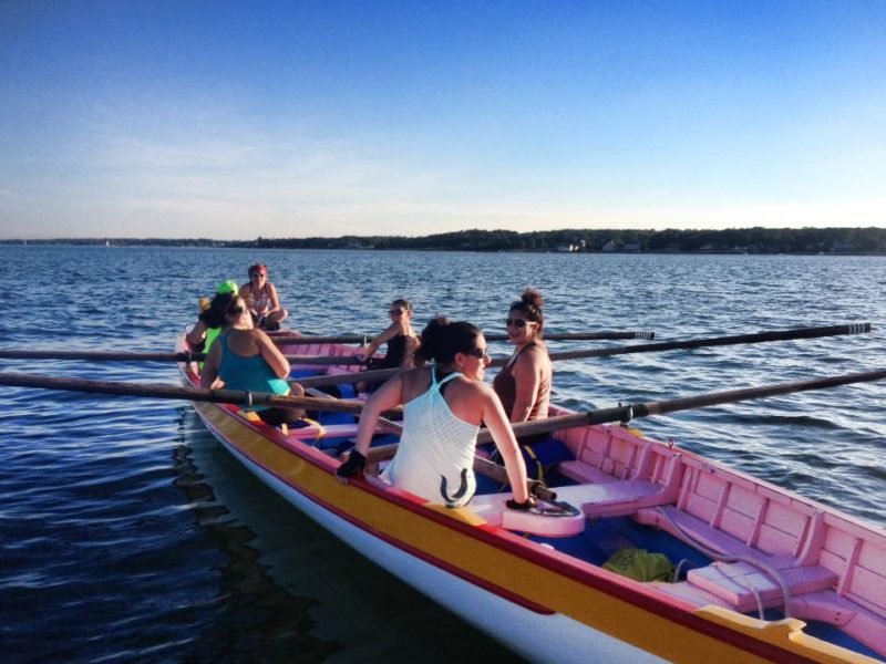 women sitting on an Azorean whaleboat in Clarks Cove in New Bedford