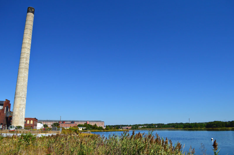 shoreline of the Acushnet River with a factory along the water