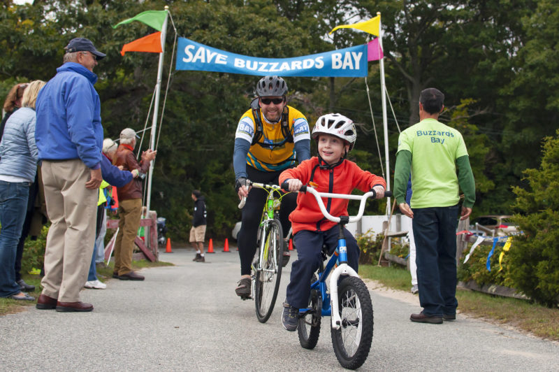 father and son crossing the finish line at the Buzzards Bay Watershed Ride