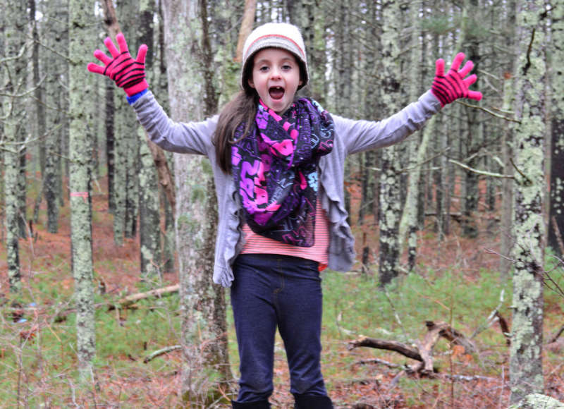 girl standing on a rock in Minot Forest