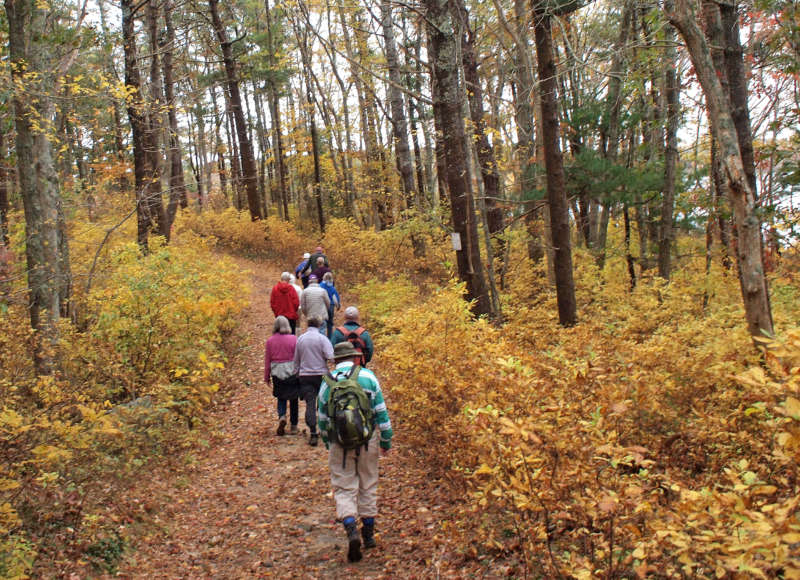 people hiking on the glacial moraine trail in Falmouth