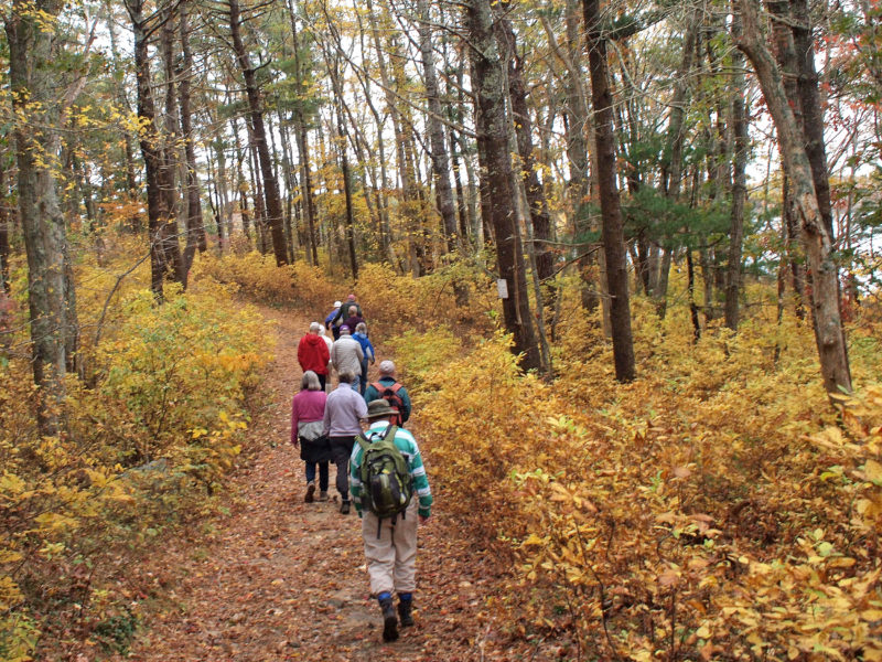 people hiking on the glacial moraine trail in Falmouth