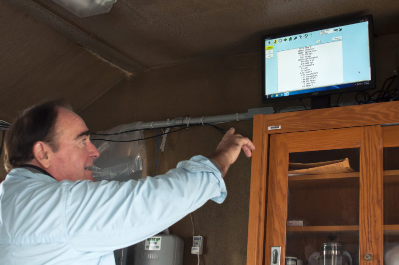 Massachusetts Maritime Academy professor pointing at a computer screen