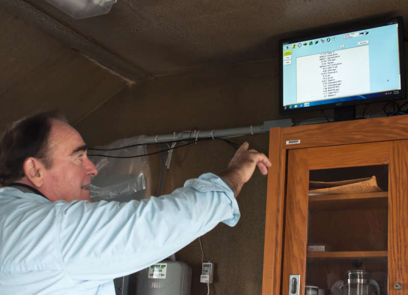 Massachusetts Maritime Academy professor pointing at a computer screen