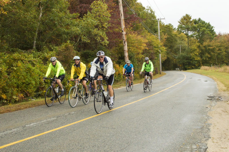 a group of cyclists on a country road in Mattapoisett in fall