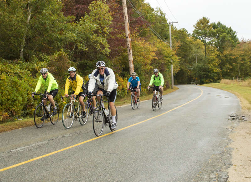 a group of cyclists on a country road in Mattapoisett in fall