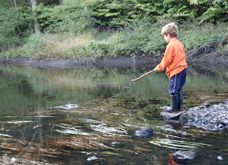 young boy fishing in the Weweantic River at Horseshoe Mill in Wareham