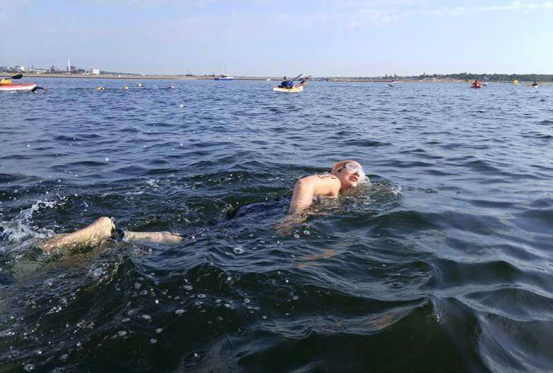 Rosie Byrnes swimming across outer New Bedford Harbor at the Buzzards Bay Swim