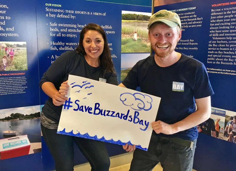 two people holding a Save Buzzards Bay March for Science sign