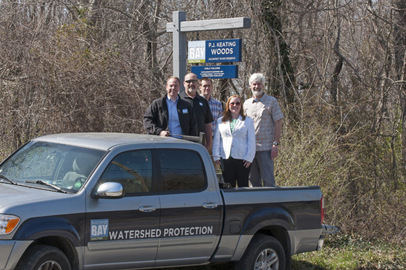 Buzzards Bay Coalition staff with P.J. Keating Company at new protected property in Acushnet
