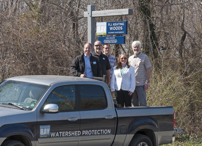 Buzzards Bay Coalition staff with P.J. Keating Company at new protected property in Acushnet