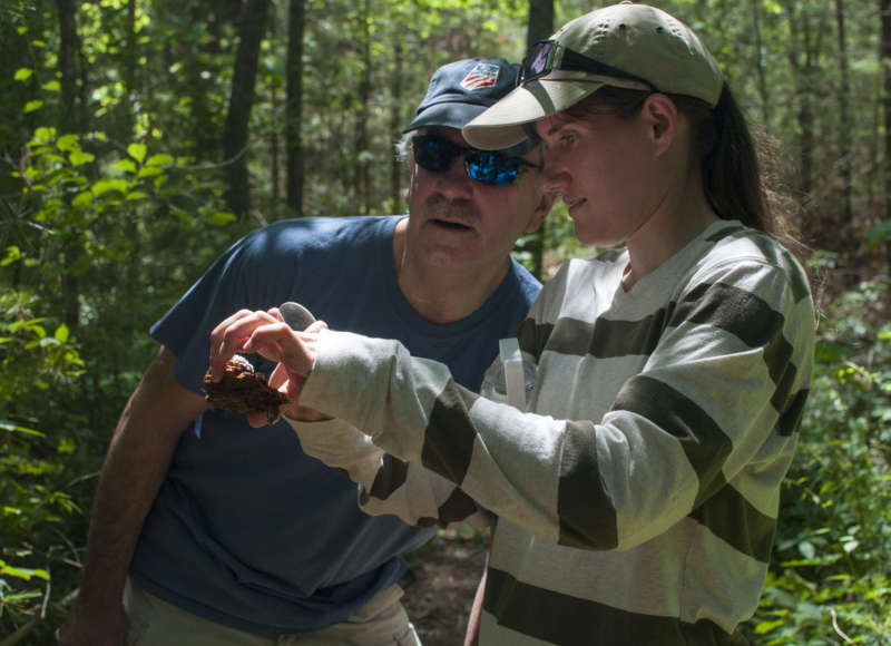 two people examining a fungus foraged from the woods