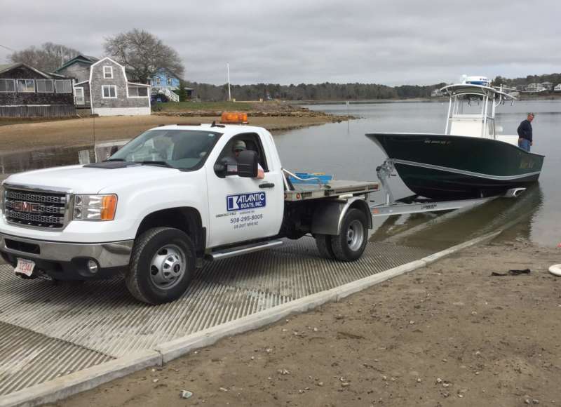 people launching a boat into Broad Cove from the Onset boat ramp in Wareham