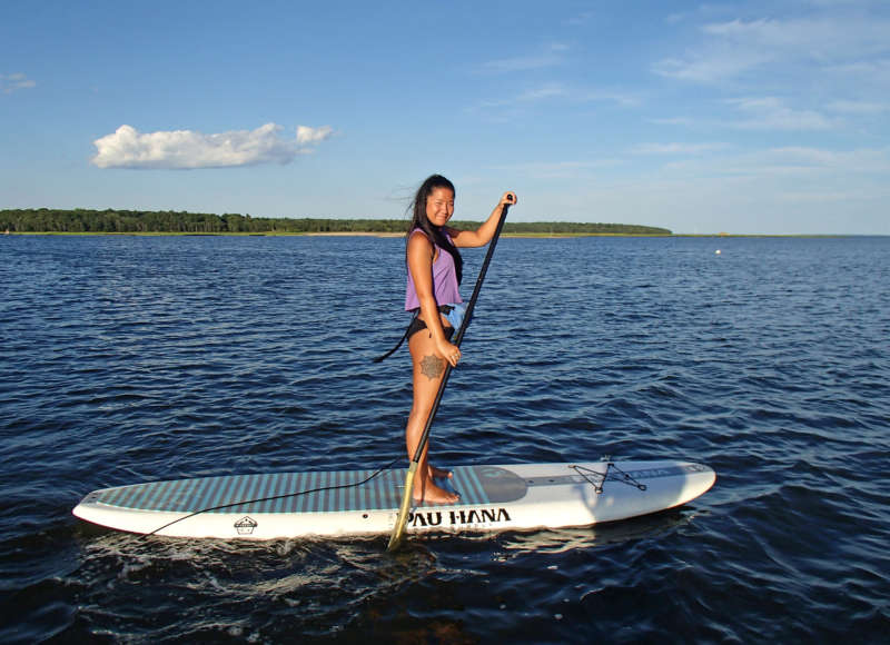 woman paddleboarding in Little Bay in Fairhaven