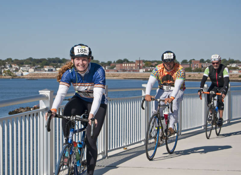 Three people biking on the New Bedford CoveWalk during the Buzzards Bay Watershed Ride.